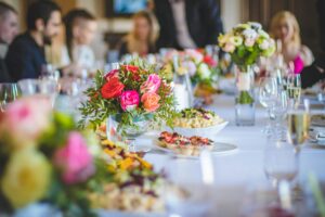 Beautifully set dining table with vibrant floral arrangements and elegant tableware.